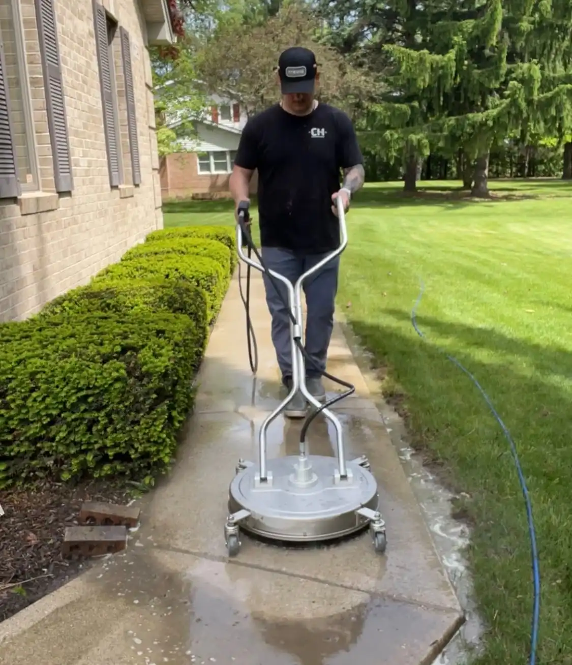 Surface cleaner pressure washing sidewalk in Saline MI
